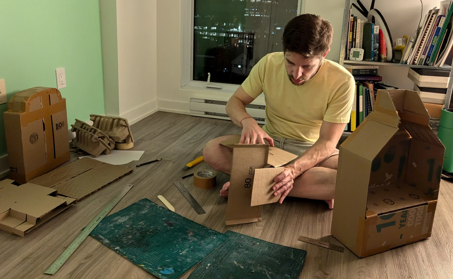 Phil piecing together the cross part of a cardboard gravestone