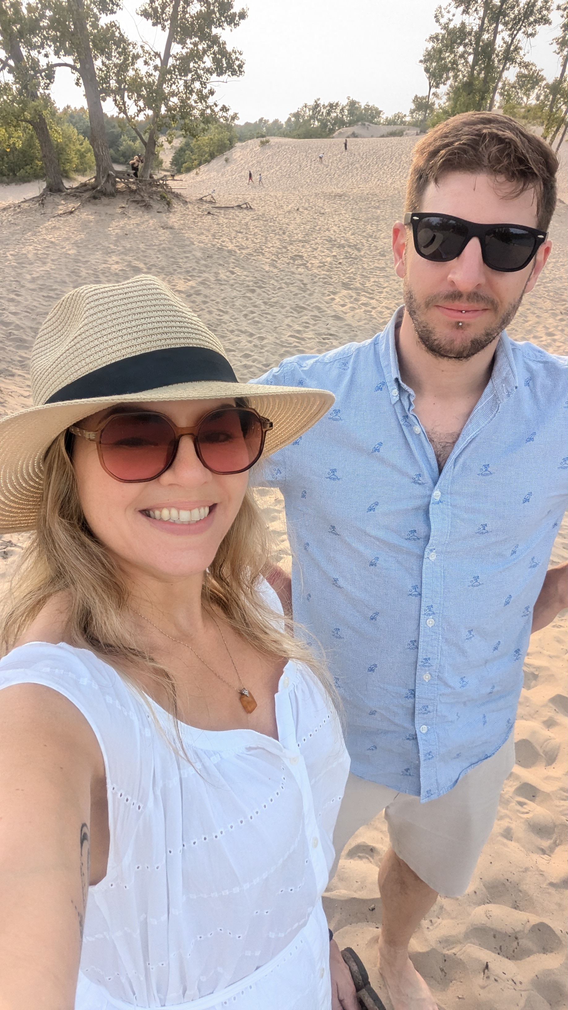 Laura and Phil standing on a dune at Sand Banks Provincial Park