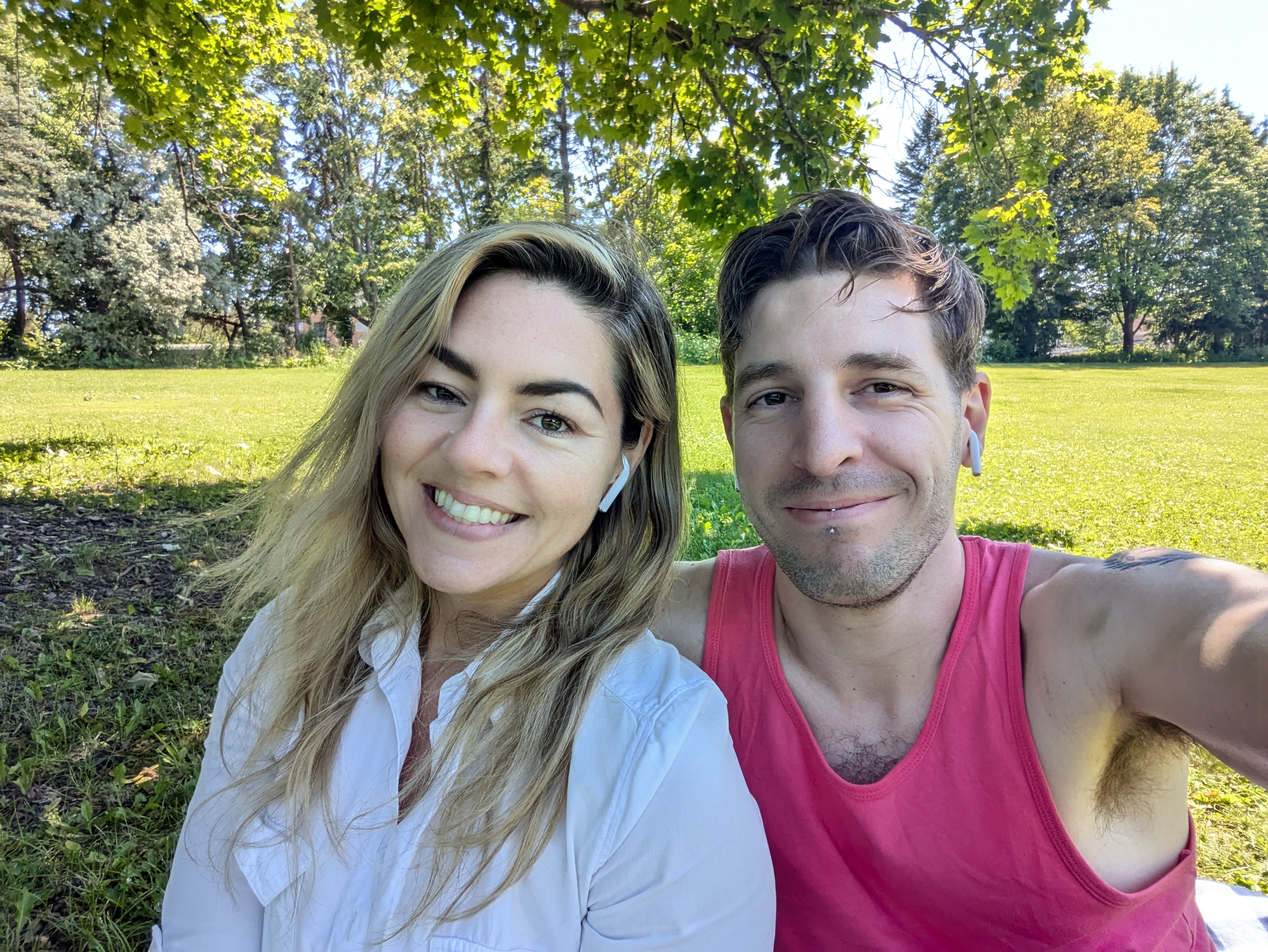 A selfie of Laura and Phil smiling in a park